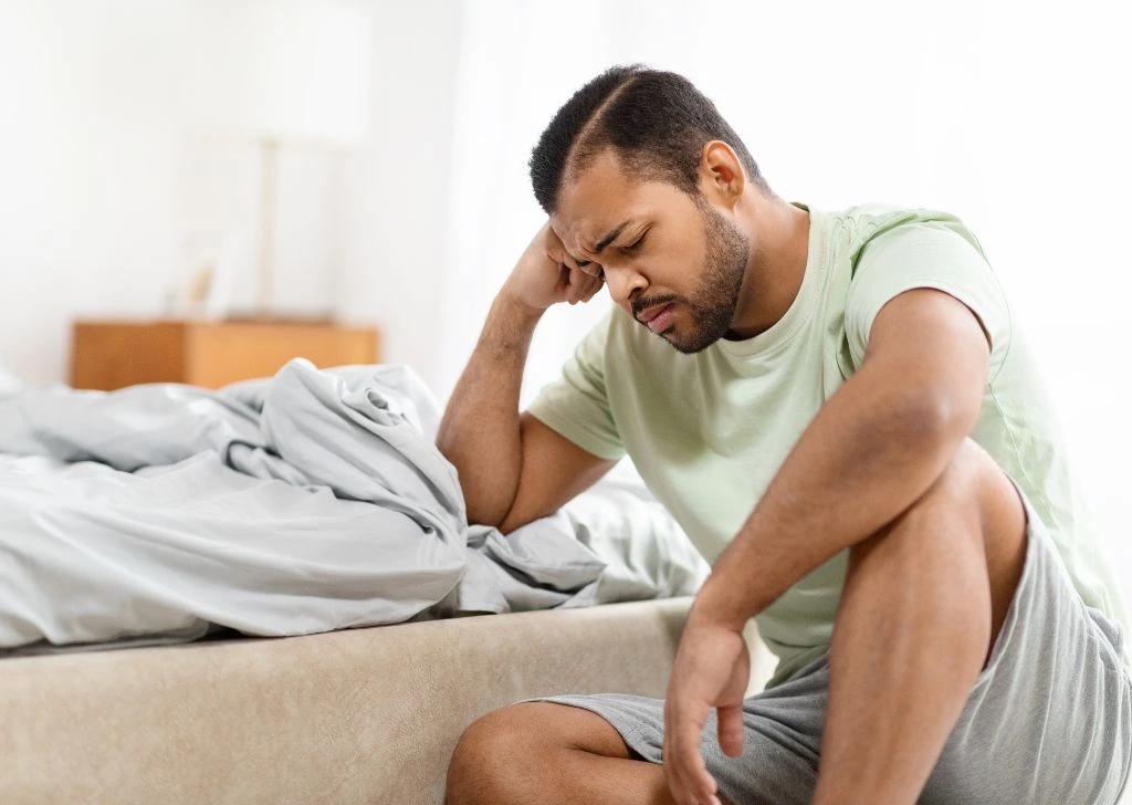 A man is emotionally distressed in his sex life caused by his curved penis.