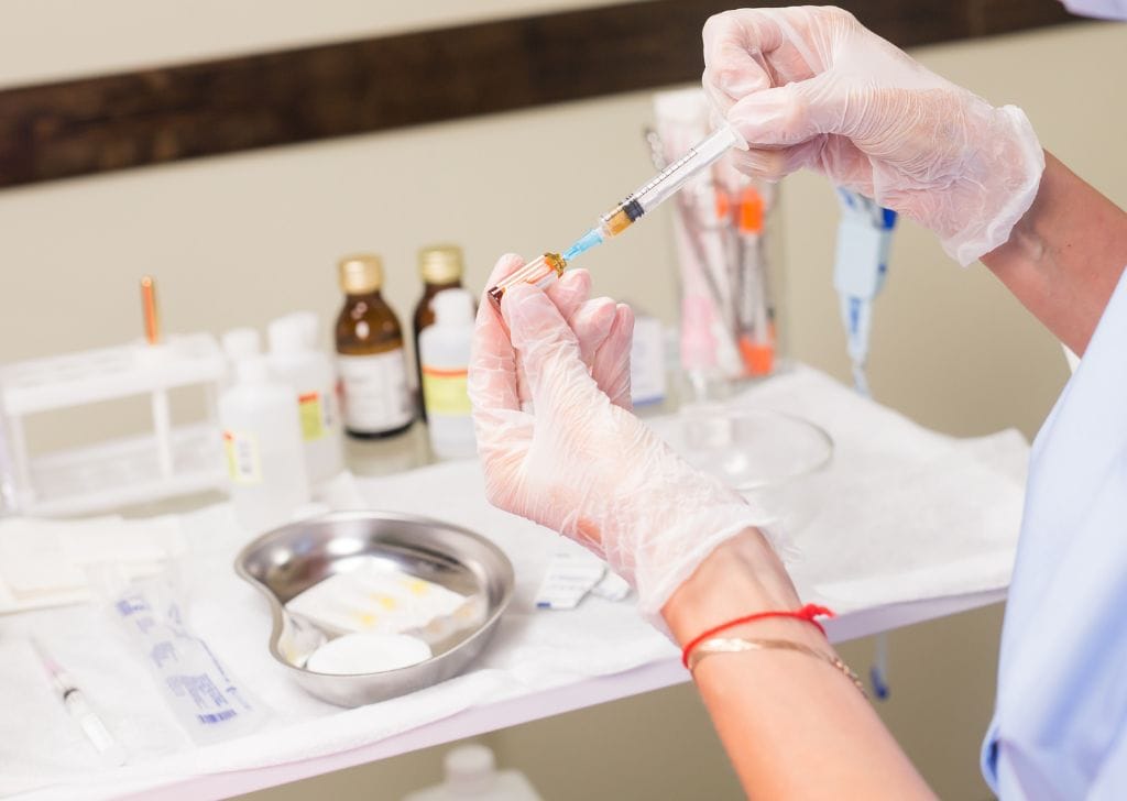 A doctor preparing to administer a P Shot treatment for a patient.