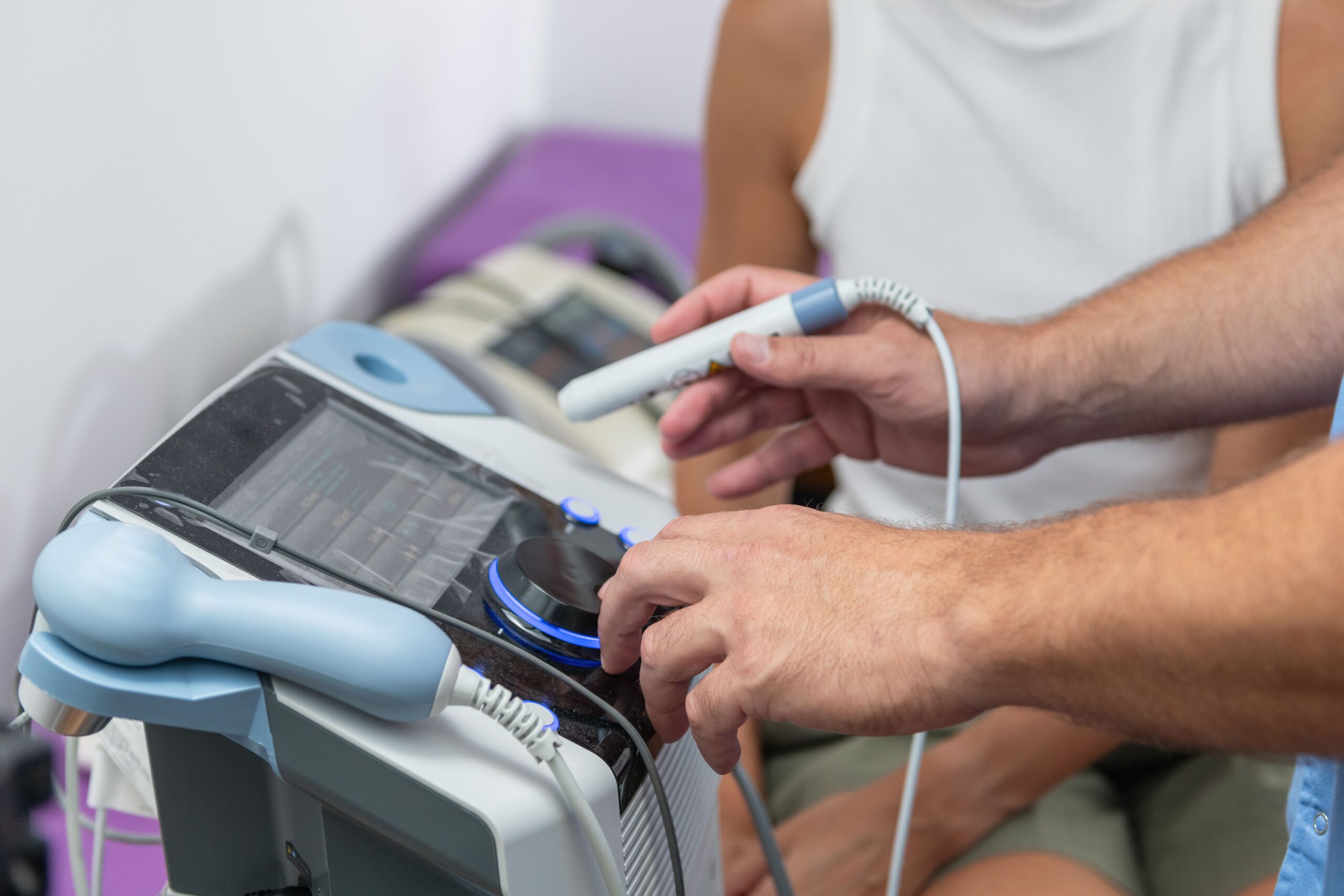 Erectile Dysfunction Treatment in Malaysia: What Are Your Options? 2 A patient is fully clothed while a healthcare provider conducts an ultrasound check during shockwave therapy for ED.